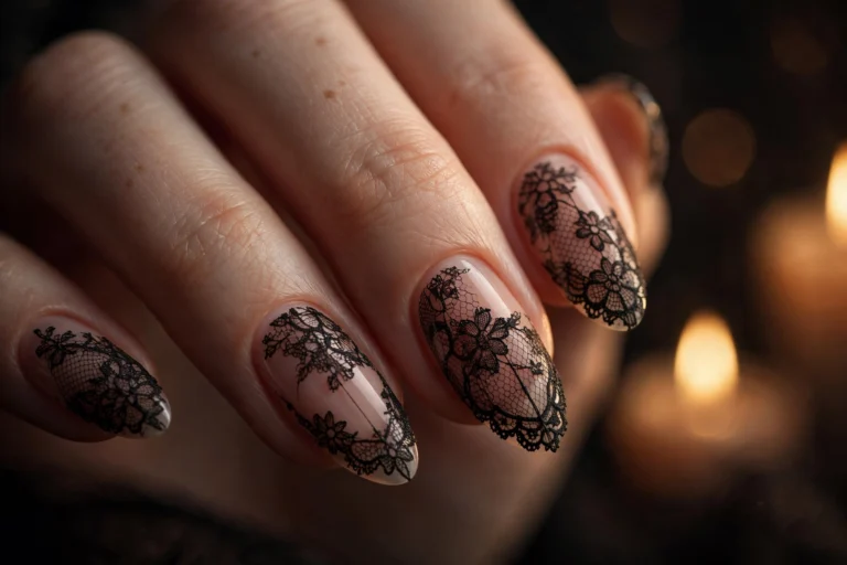 Close-up of dark romantic lace nail art — black lace pattern over nude almond-shaped nails